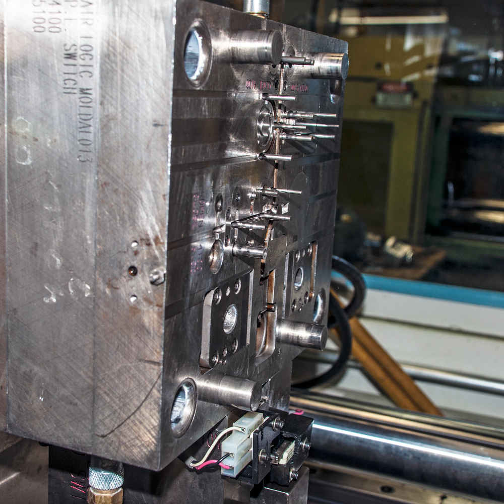 Tool and die maker measuring a mold component